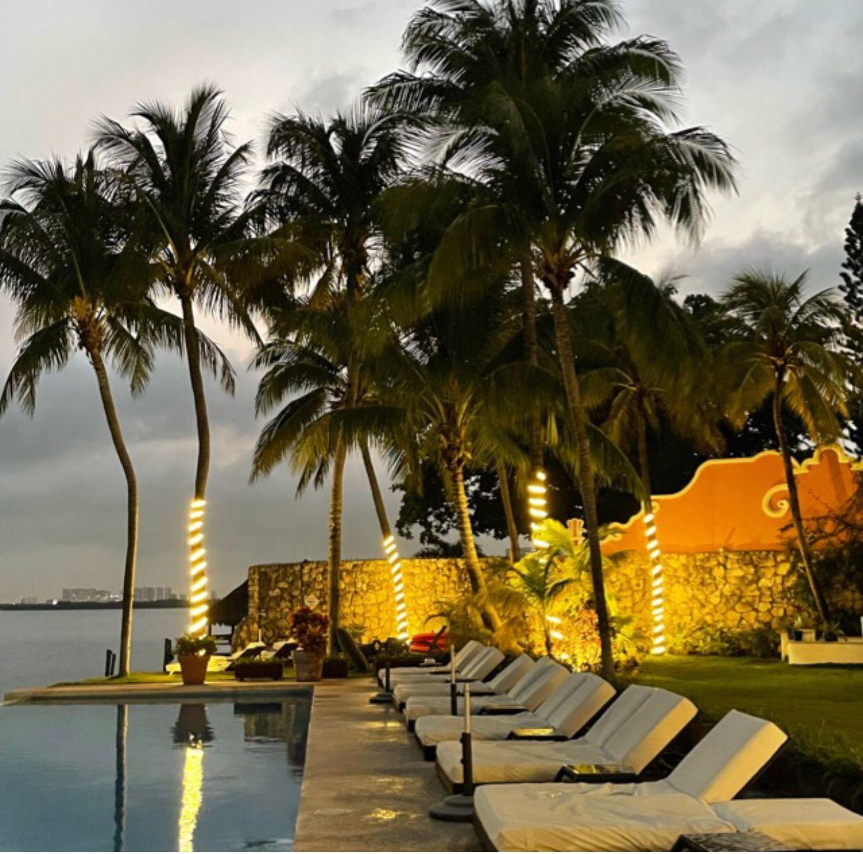 Sun loungers by the pool at Casa Tortugas during evening