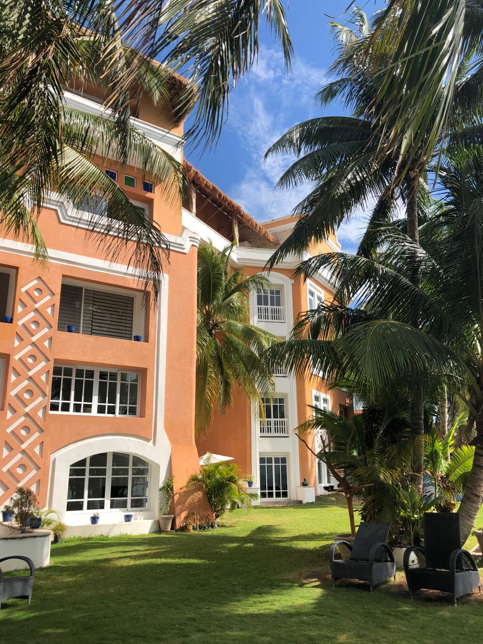 Lush garden and hotel facade at Casa Tortugas
