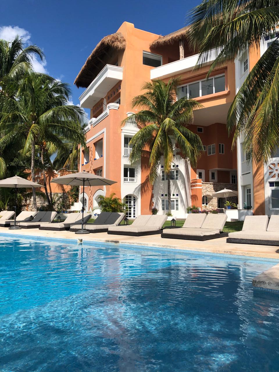 Sunset pool and building facade at Casa Tortugas