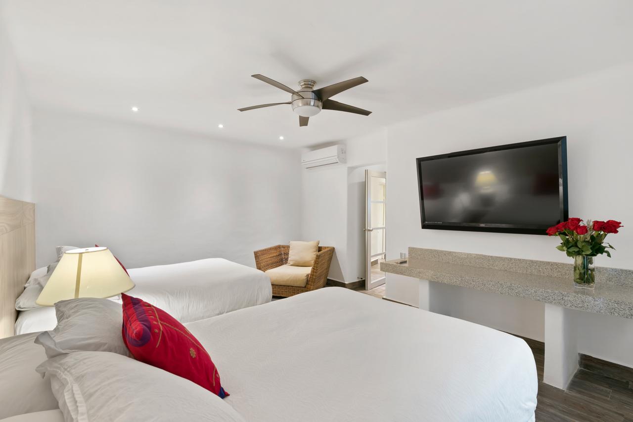 Second bedroom with two Double beds in the Two-Bedroom Lagoon View Suite at Casa Tortugas Boutique Hotel